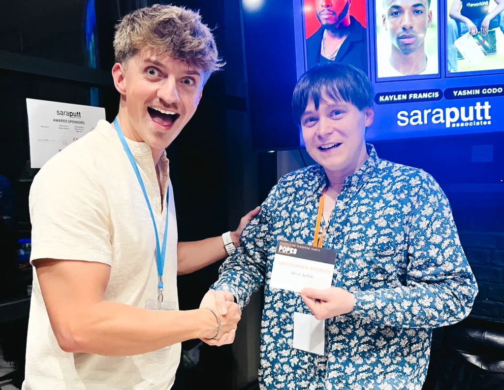 Nathan Caselton awarding actor Christopher Buckley with Sara Putt Associates