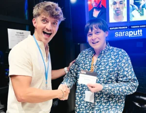 Nathan Caselton awarding actor Christopher Buckley with Sara Putt Associates